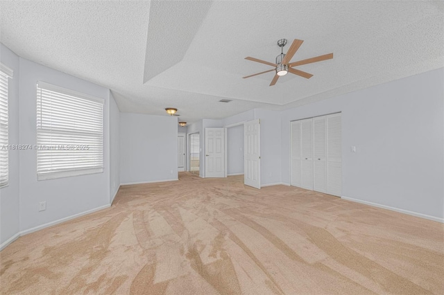 2256 SW 183rd Ter, Miramar, FL 33029 - unfurnished living room with a textured ceiling, a ceiling fan, carpet flooring, and baseboards