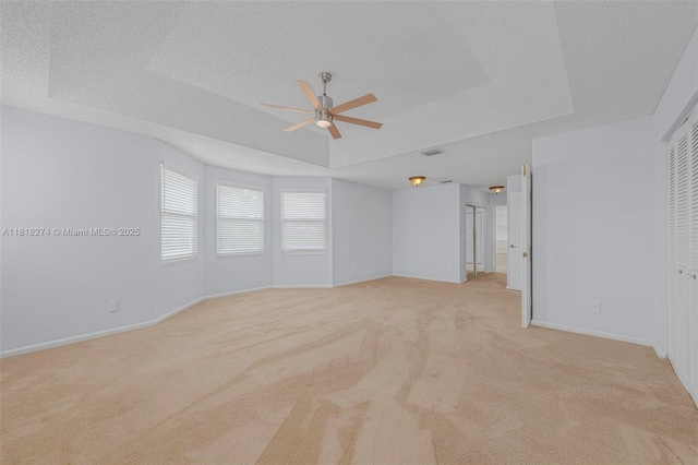 2256 SW 183rd Ter, Miramar, FL 33029 - unfurnished room featuring light colored carpet, ceiling fan, a tray ceiling, baseboards, and a textured ceiling