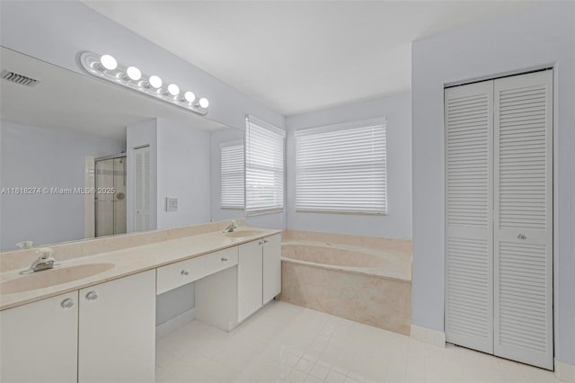 2256 SW 183rd Ter, Miramar, FL 33029 - bathroom with a closet, a garden tub, a stall shower, double vanity, and tile patterned flooring