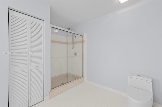2256 SW 183rd Ter, Miramar, FL 33029 - bathroom featuring a closet, toilet, a stall shower, tile patterned floors, and baseboards
