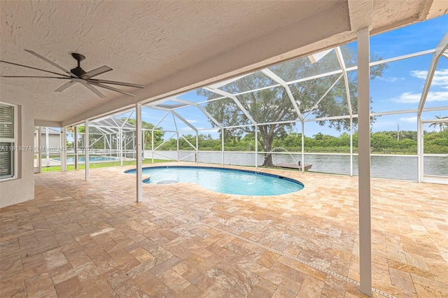2256 SW 183rd Ter, Miramar, FL 33029 - outdoor pool with a patio, glass enclosure, a water view, and ceiling fan