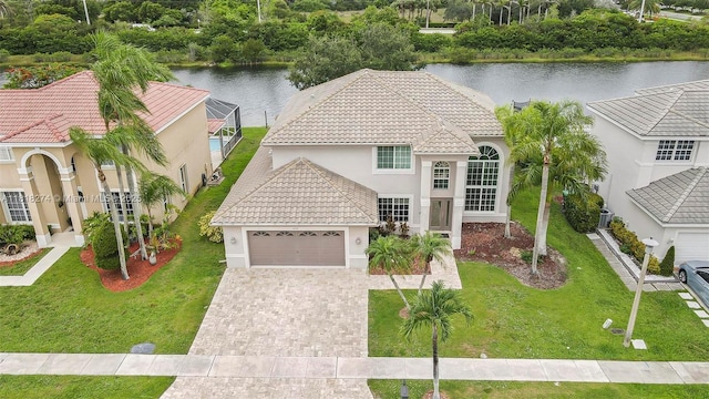2256 SW 183rd Ter, Miramar, FL 33029 - mediterranean / spanish-style home featuring a tile roof, stucco siding, a water view, and a garage