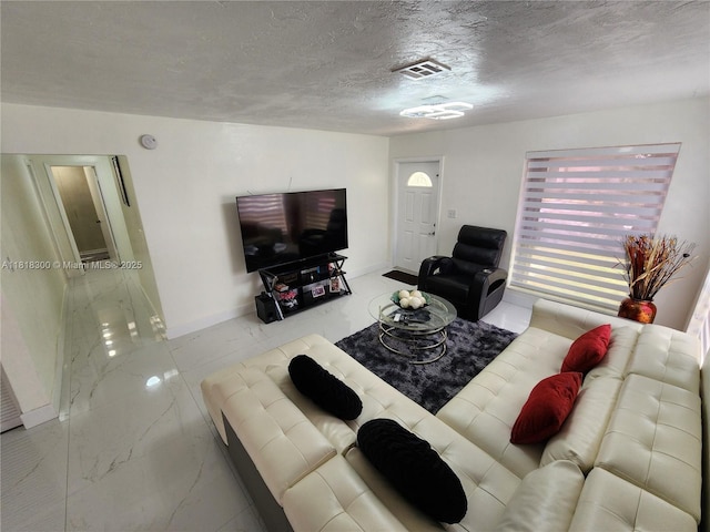11820 SW 125th Pl Unit 11820, Miami, FL 33186 - living room featuring marble finish flooring, baseboards, and a textured ceiling