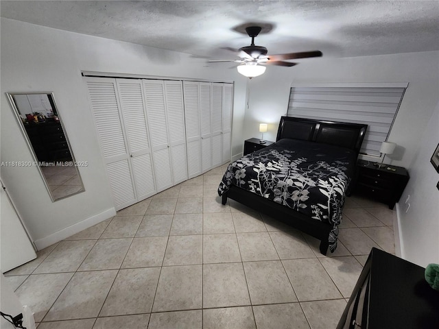 11820 SW 125th Pl Unit 11820, Miami, FL 33186 - bedroom with tile patterned floors, a ceiling fan, a textured ceiling, a closet, and baseboards