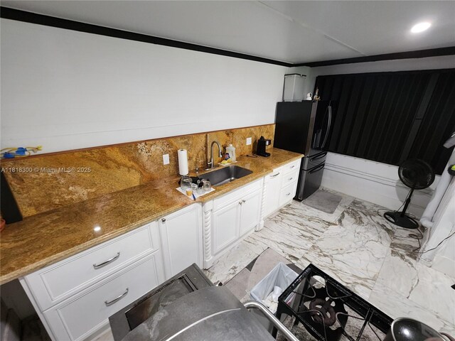 11820 SW 125th Pl Unit 11820, Miami, FL 33186 - kitchen featuring black fridge, a sink, white cabinetry, light marble finish floors, and light stone counters