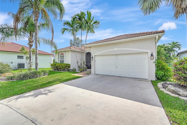 2775 Dunwoodie Pl, Homestead, FL 33035 - mediterranean / spanish home featuring stucco siding, concrete driveway, an attached garage, a front yard, and a tiled roof