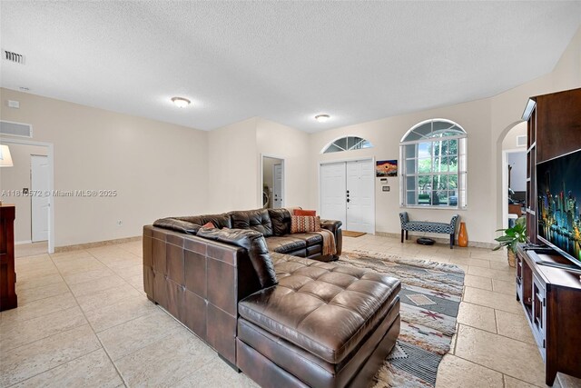 2775 Dunwoodie Pl, Homestead, FL 33035 - living room with a textured ceiling, light tile patterned floors, and baseboards