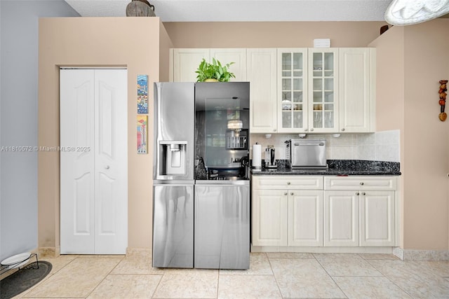 2775 Dunwoodie Pl, Homestead, FL 33035 - kitchen featuring stainless steel refrigerator with ice dispenser, glass insert cabinets, decorative backsplash, white cabinetry, and light tile patterned flooring
