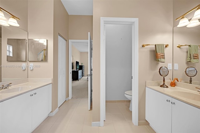2775 Dunwoodie Pl, Homestead, FL 33035 - bathroom with two vanities, toilet, tile patterned floors, and baseboards