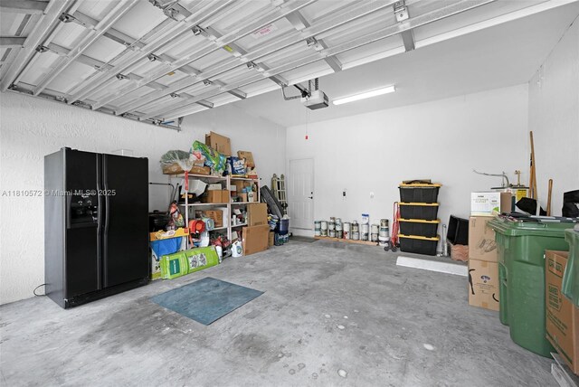 2775 Dunwoodie Pl, Homestead, FL 33035 - garage featuring black fridge with ice dispenser and a garage door opener