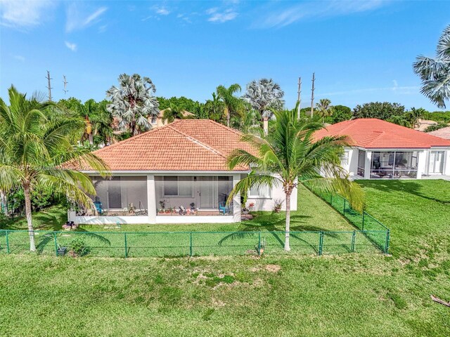 2775 Dunwoodie Pl, Homestead, FL 33035 - rear view of house featuring a sunroom, a tile roof, and stucco siding