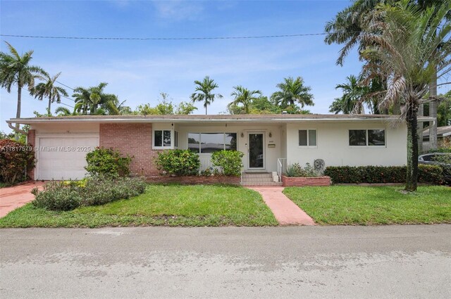 1231 N 15th Ct, Hollywood, FL 33020 - ranch-style home with a garage, a front yard, driveway, and stucco siding