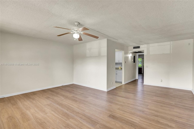 1551 SW 135th Ter Unit 112G, Pembroke Pines, FL 33027 - spare room featuring light wood-type flooring, a ceiling fan, and a textured ceiling