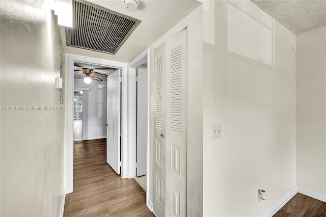 1551 SW 135th Ter Unit 112G, Pembroke Pines, FL 33027 - corridor featuring wood finished floors and a textured ceiling