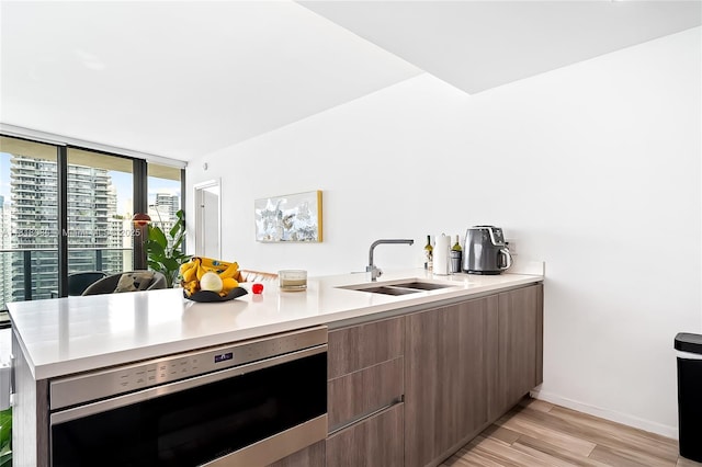 801 S Miami Ave Unit 3704, Miami, FL 33130 - kitchen with modern cabinets, light wood finished floors, light countertops, and oven