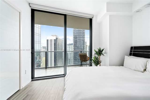 801 S Miami Ave Unit 3704, Miami, FL 33130 - bedroom with a wall of windows, wood finished floors, a view of city, and access to exterior