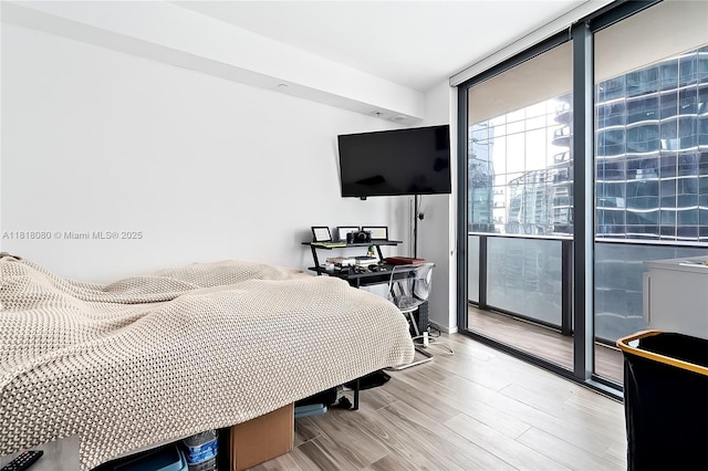801 S Miami Ave Unit 3704, Miami, FL 33130 - bedroom with a wall of windows, access to exterior, and wood finished floors