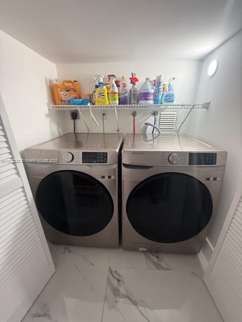 14085 SW 179th Ter, Miami, FL 33177 - laundry room featuring separate washer and dryer and marble look tile flooring