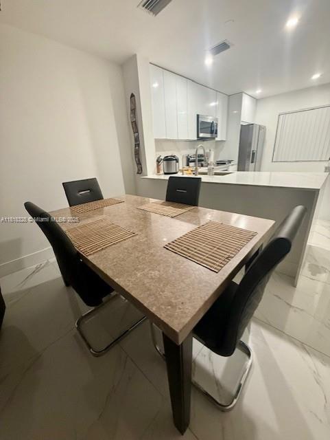 14085 SW 179th Ter, Miami, FL 33177 - dining area with light marble finish floors and recessed lighting