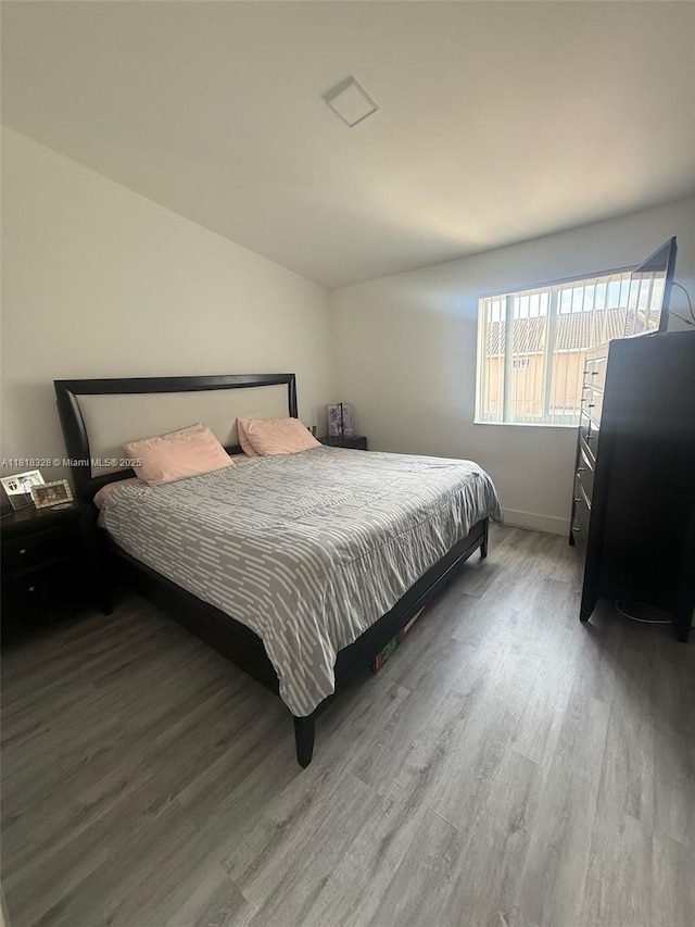 14085 SW 179th Ter, Miami, FL 33177 - bedroom featuring wood finished floors, vaulted ceiling, and baseboards