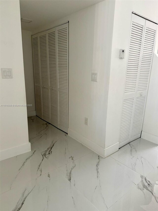 14085 SW 179th Ter, Miami, FL 33177 - unfurnished bedroom with baseboards, marble finish floors, and a closet