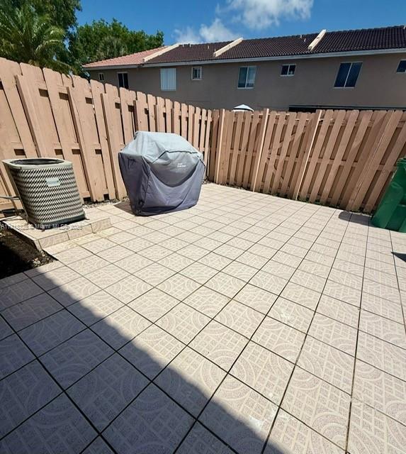 14085 SW 179th Ter, Miami, FL 33177 - view of patio / terrace featuring grilling area and central air condition unit