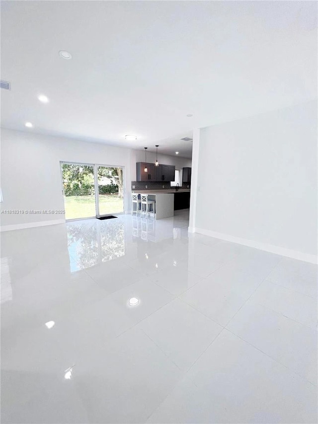 730 Alabama Ave, Fort Lauderdale, FL 33312 - unfurnished living room featuring light tile patterned floors, baseboards, and recessed lighting