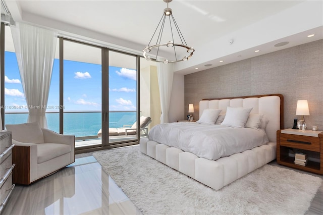 17901 Collins Ave Unit 1903, Sunny Isles Beach, FL 33160 - bedroom featuring a chandelier, expansive windows, access to outside, and a water view