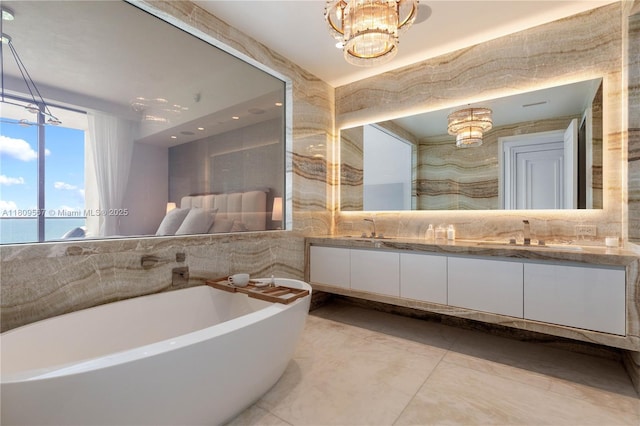17901 Collins Ave Unit 1903, Sunny Isles Beach, FL 33160 - bathroom with double vanity, a soaking tub, a chandelier, and tile walls