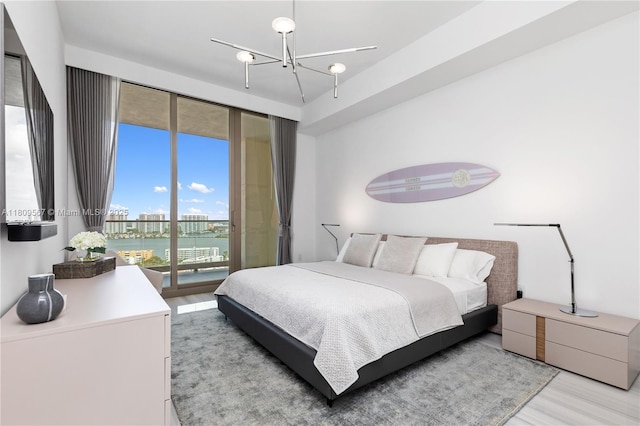 17901 Collins Ave Unit 1903, Sunny Isles Beach, FL 33160 - bedroom featuring access to exterior, light wood finished floors, a chandelier, and a water view