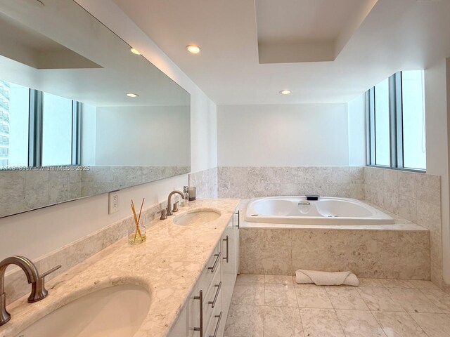 1331 Brickell Bay Dr Unit 2002, Miami, FL 33131 - bathroom featuring a garden tub, double vanity, tile patterned floors, and recessed lighting