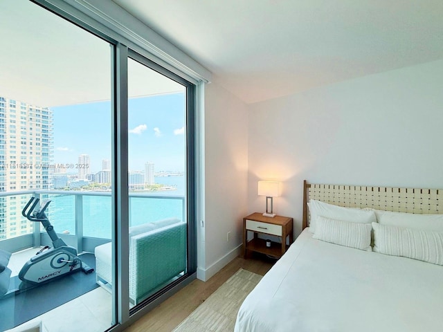 1331 Brickell Bay Dr Unit 2002, Miami, FL 33131 - bedroom with light wood-type flooring, a view of city, and baseboards