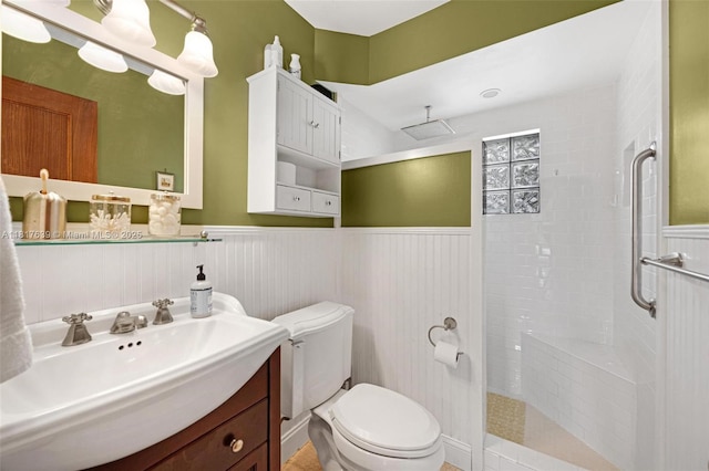 11537 SW 34th Ln, Miami, FL 33165 - bathroom with wainscoting, tiled shower, vanity, and toilet