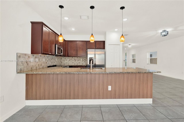 279 SE 31st Ter, Homestead, FL 33033 - kitchen featuring appliances with stainless steel finishes, a peninsula, light tile patterned flooring, decorative backsplash, and recessed lighting