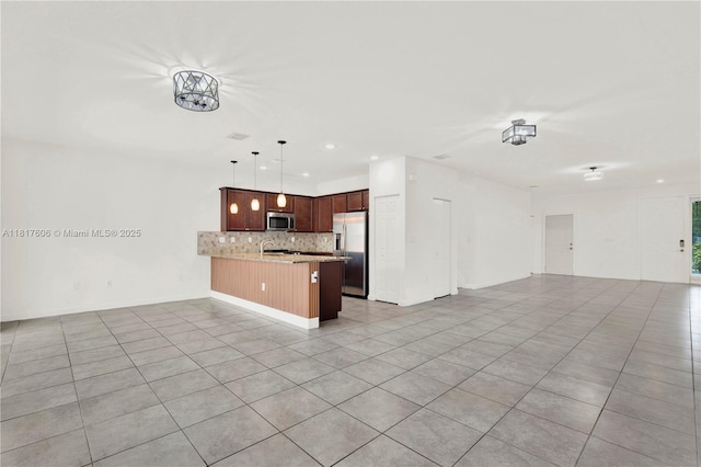 279 SE 31st Ter, Homestead, FL 33033 - kitchen featuring open floor plan, appliances with stainless steel finishes, a peninsula, tasteful backsplash, and recessed lighting