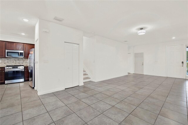 279 SE 31st Ter, Homestead, FL 33033 - spare room with light tile patterned floors, stairway, and recessed lighting