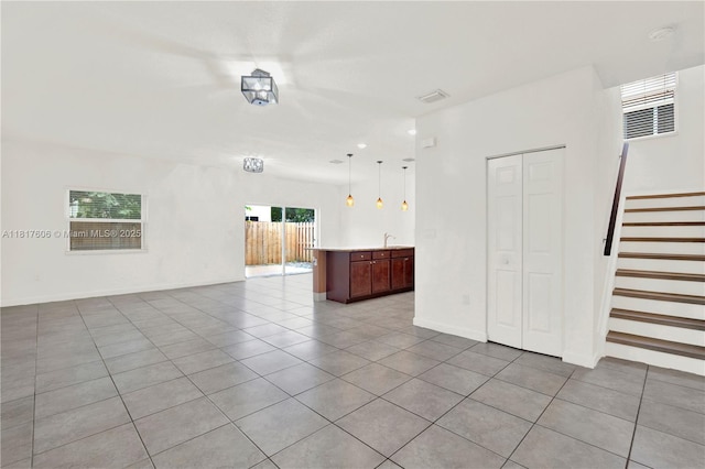 279 SE 31st Ter, Homestead, FL 33033 - unfurnished living room with tile patterned floors and stairway