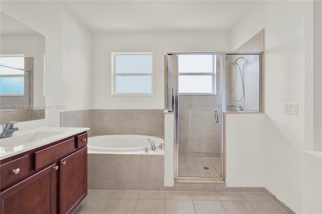 279 SE 31st Ter, Homestead, FL 33033 - bathroom with vanity, a garden tub, a shower stall, and tile patterned floors