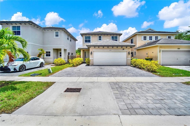279 SE 31st Ter, Homestead, FL 33033 - view of front of house featuring decorative driveway, an attached garage, and stucco siding