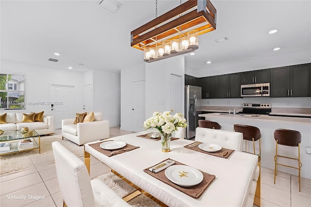 2652 SE 13th St, Homestead, FL 33035 - dining space with light tile patterned flooring, recessed lighting, and a chandelier