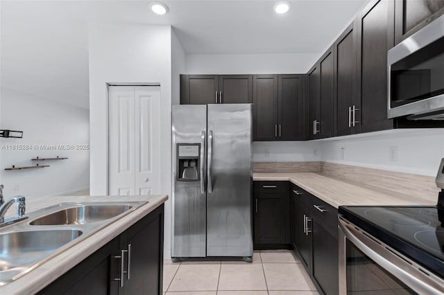 2652 SE 13th St, Homestead, FL 33035 - kitchen featuring appliances with stainless steel finishes, a sink, light countertops, light tile patterned floors, and recessed lighting