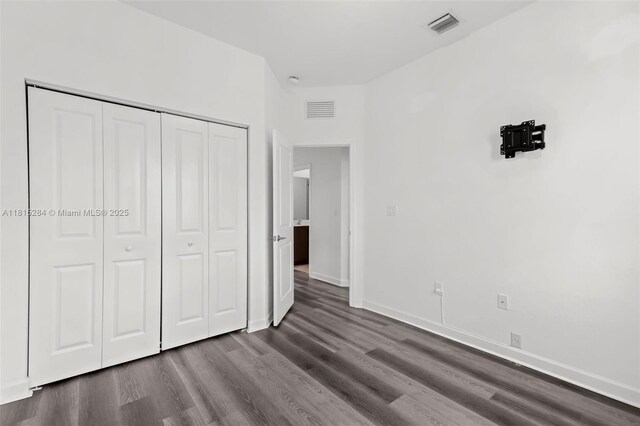 2652 SE 13th St, Homestead, FL 33035 - unfurnished bedroom with dark wood-style floors, a closet, and baseboards