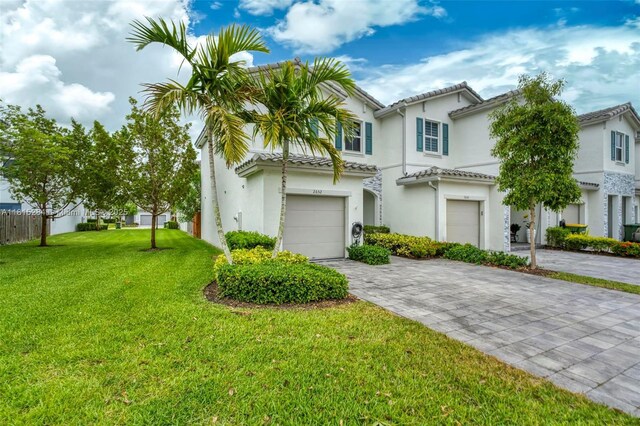 2652 SE 13th St, Homestead, FL 33035 - view of front facade with a garage, decorative driveway, stucco siding, and a tile roof