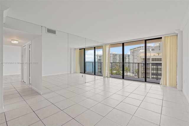 1450 Brickell Bay Dr Unit 806, Miami, FL 33131 - unfurnished room featuring expansive windows, light tile patterned floors, and baseboards