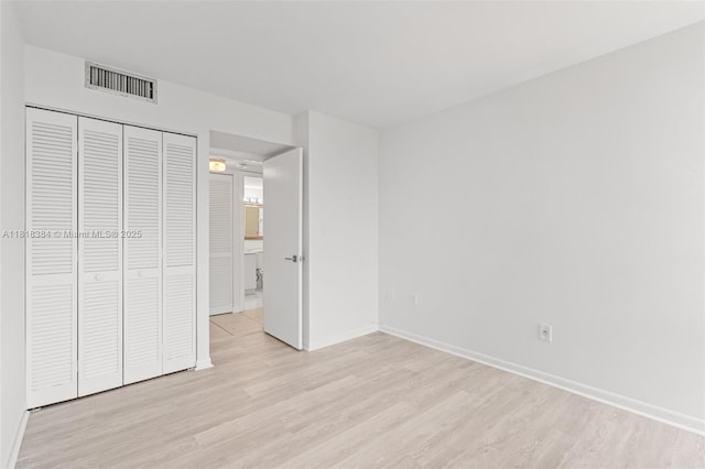 1450 Brickell Bay Dr Unit 806, Miami, FL 33131 - unfurnished bedroom featuring light wood-style floors, baseboards, and a closet