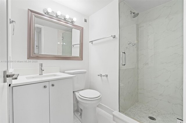1450 Brickell Bay Dr Unit 806, Miami, FL 33131 - bathroom with a marble finish shower, toilet, vanity, and baseboards
