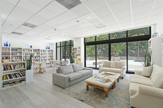 1450 Brickell Bay Dr Unit 806, Miami, FL 33131 - living room featuring a wall of windows, wood finished floors, and a drop ceiling