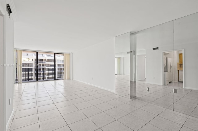 1450 Brickell Bay Dr Unit 806, Miami, FL 33131 - unfurnished room featuring light tile patterned floors, expansive windows, and baseboards