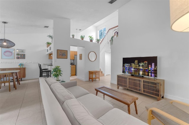 9550 SW 140th Ct Unit 9550, Miami, FL 33186 - living area featuring light tile patterned flooring, a towering ceiling, and baseboards