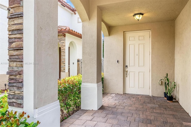 150 NE 23rd Ter, Homestead, FL 33033 - doorway to property with stucco siding and a tiled roof